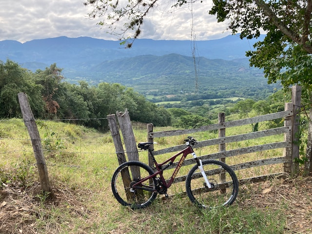 A bicycle against a rustic fence in the countryside near Ainhoa